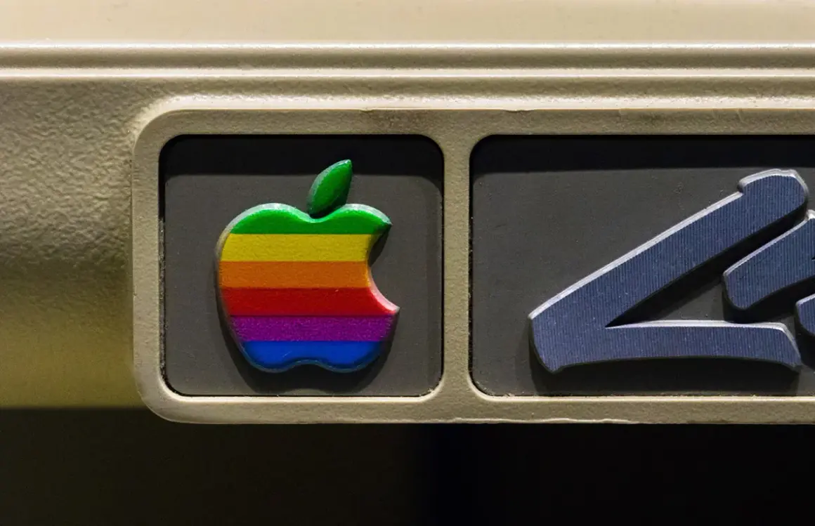 The iconic rainbow Apple logo, a testament to the original apple logo designer's vision, adorns an old computer.