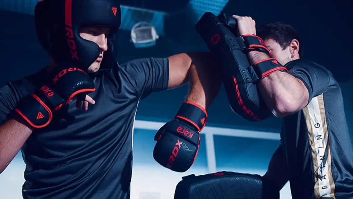 Two boxers train intensely, practicing punches and blocks. This image captures the spirit of a professional boxing round length, showcasing dedication and skill.