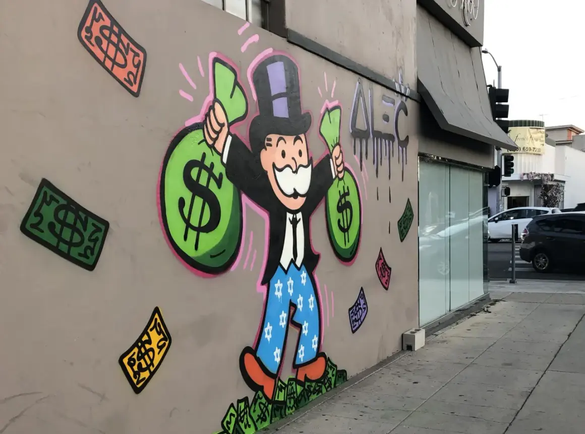 A vibrant graffiti drawing of the Monopoly Man, clutching bags of money, stands proudly on a wall. Dollar bills rain down around him, a testament to his wealth.