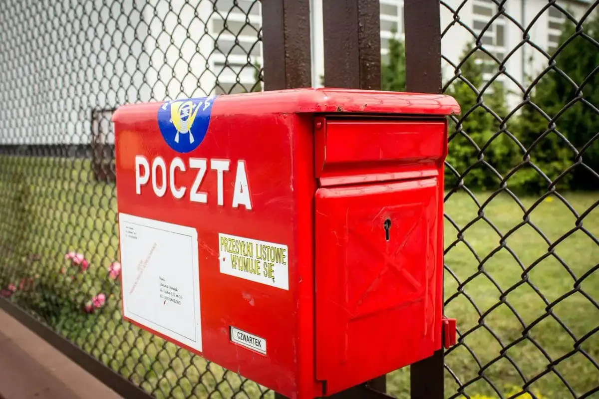 Czerwona skrzynka pocztowa, na której widnieje napis "POCZTA", skrywa tajemnicę korespondencji. Obok znajduje się naklejka "PRZESYŁKI LISTOWE WYJMUJE SIĘ".