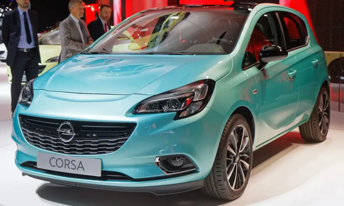 Türkisfarbener Opel Corsa mit Schriftzug "Corsa" auf dem Kühlergrill.