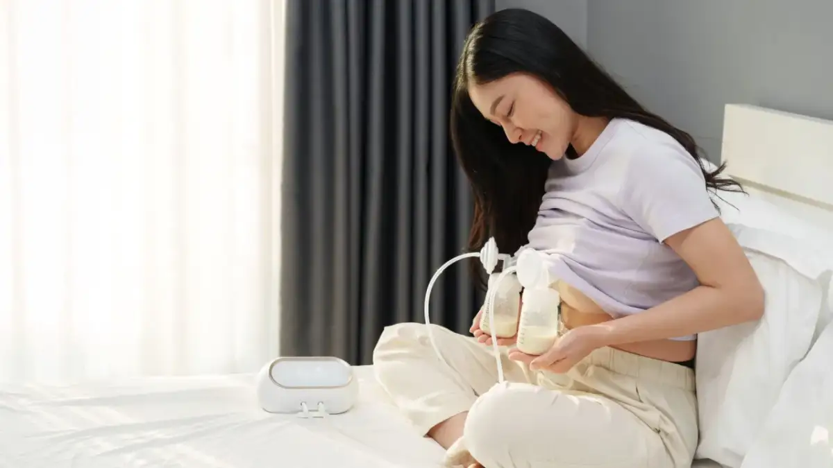 Uśmiechnięta kobieta używa laktatora, pokazując, ile jednorazowo można ściągnąć pokarmu.