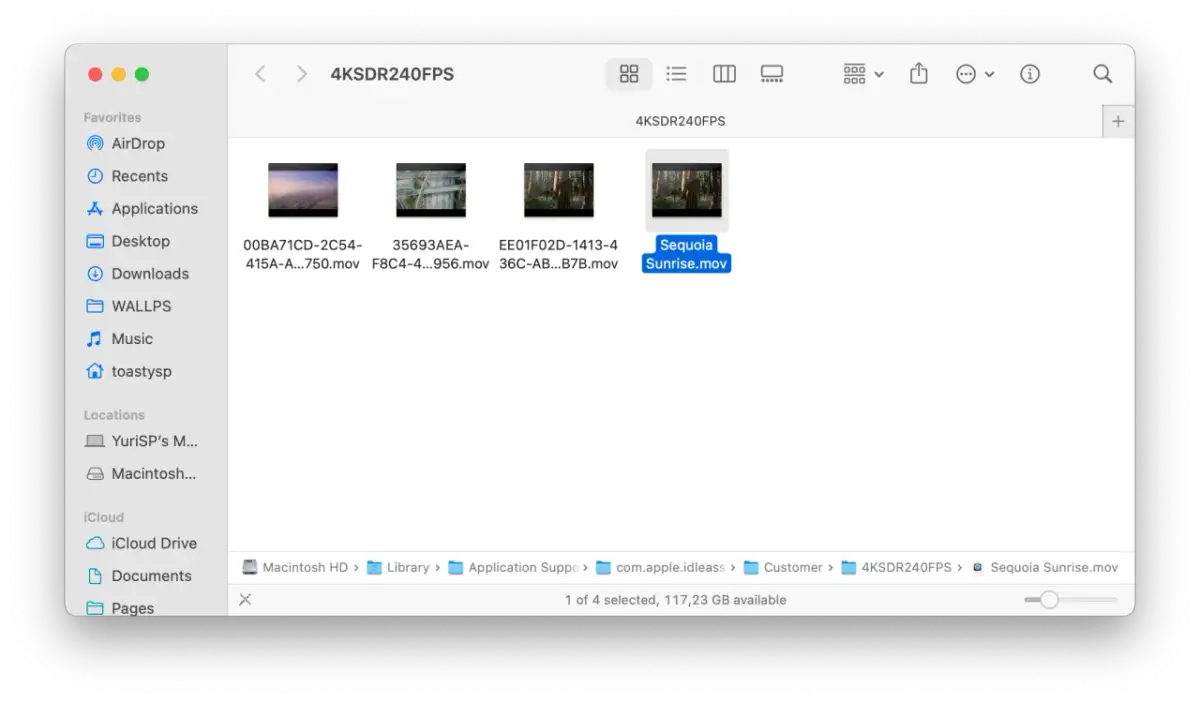 Widok folderu z plikami wideo, w tym "Sequoia Sunrise.mov". Możesz tu znaleźć inspirację, jak zmienić tapetę na laptopie.