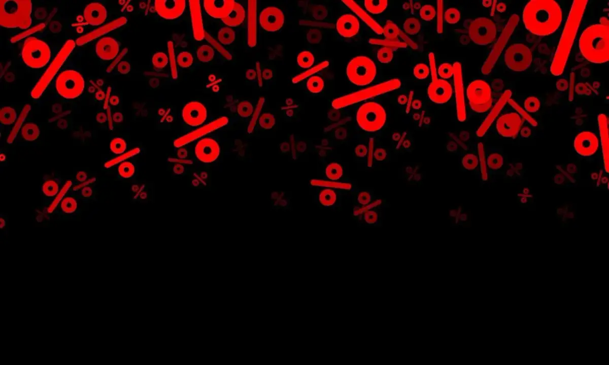 Czerwone znaki procentu na czarnym tle, symbolizujące marżę a narzut, spadają jak deszcz.