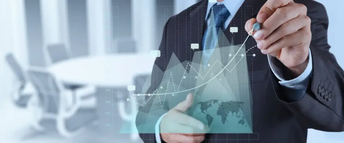 Biznesmen analizuje wykresy, pokazując przykłady procedur ISO. W tle sala konferencyjna.