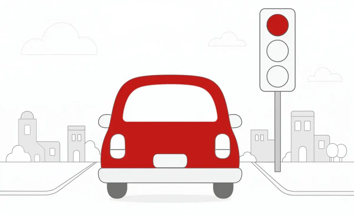 Czerwony samochód zbliża się do skrzyżowania, gdzie sygnalizator pokazuje czerwone światło. Zastanawiasz się, ile punktów karnych za przejazd na czerwonym świetle grozi w takiej sytuacji?