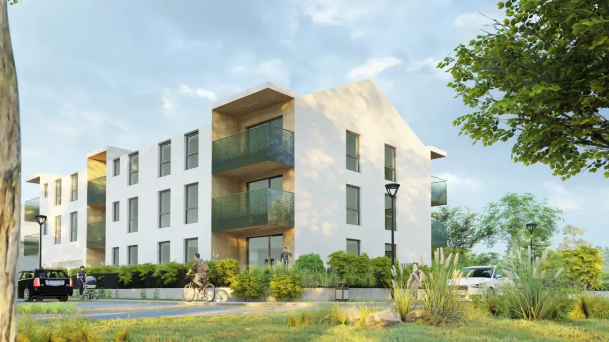 Nowoczesny budynek mieszkalny z balkonami, idealny pod leasing na nieruchomość. Obok samochody, rowerzysta i spacerowicze.