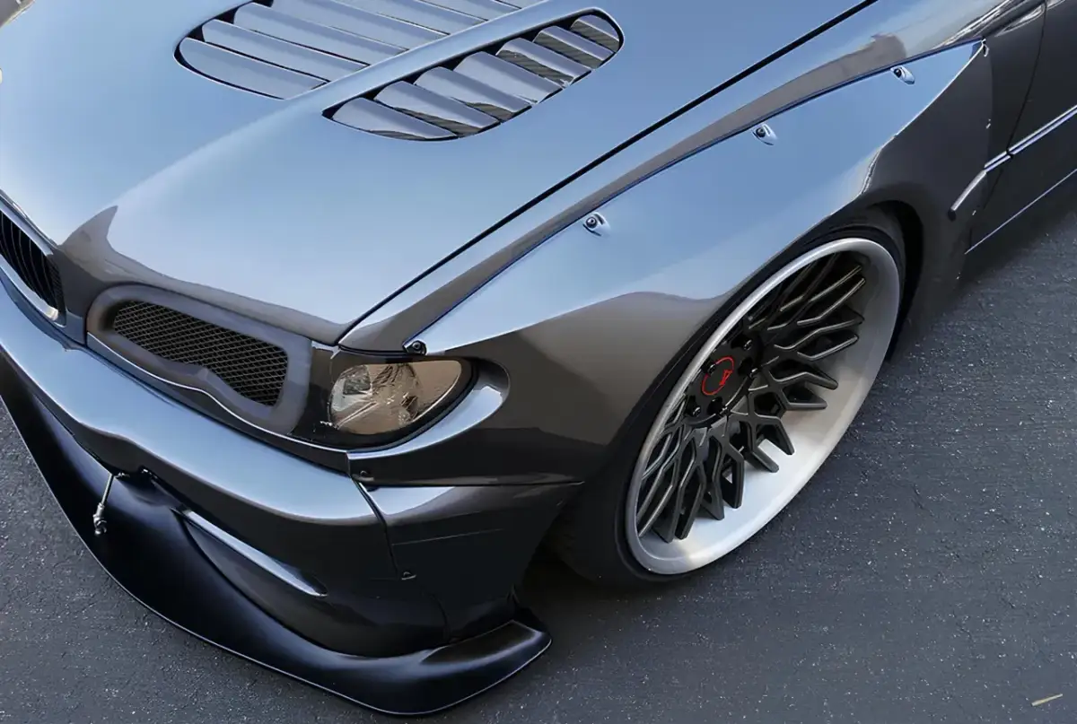 Agresywny tuning BMW E46 z poszerzeniami błotników i sportowym zderzakiem.