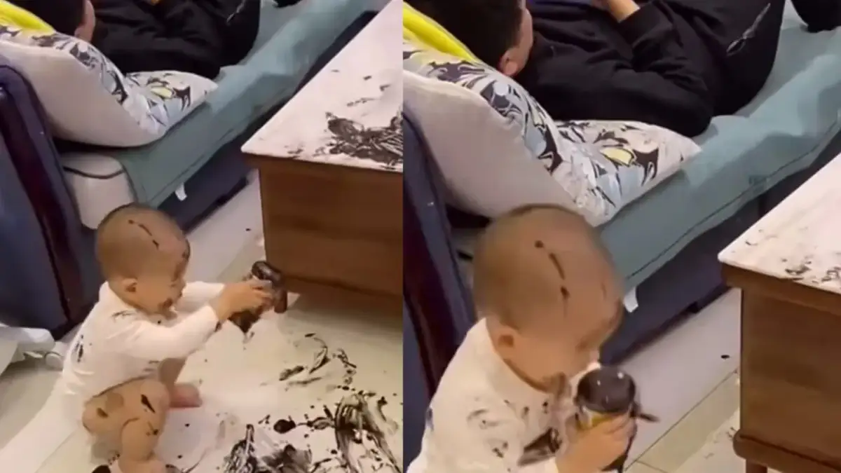 Dziecko w czarnym tuszu, gdy matka zostawia dziecko ojcu. Ojciec odpoczywa, a maluch tworzy dzieło sztuki na podłodze i sobie.