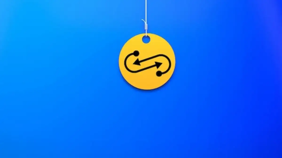 Żółty krążek z symbolem nieskończoności i strzałkami, wiszący na nitce. Czy to symbolizuje swap?