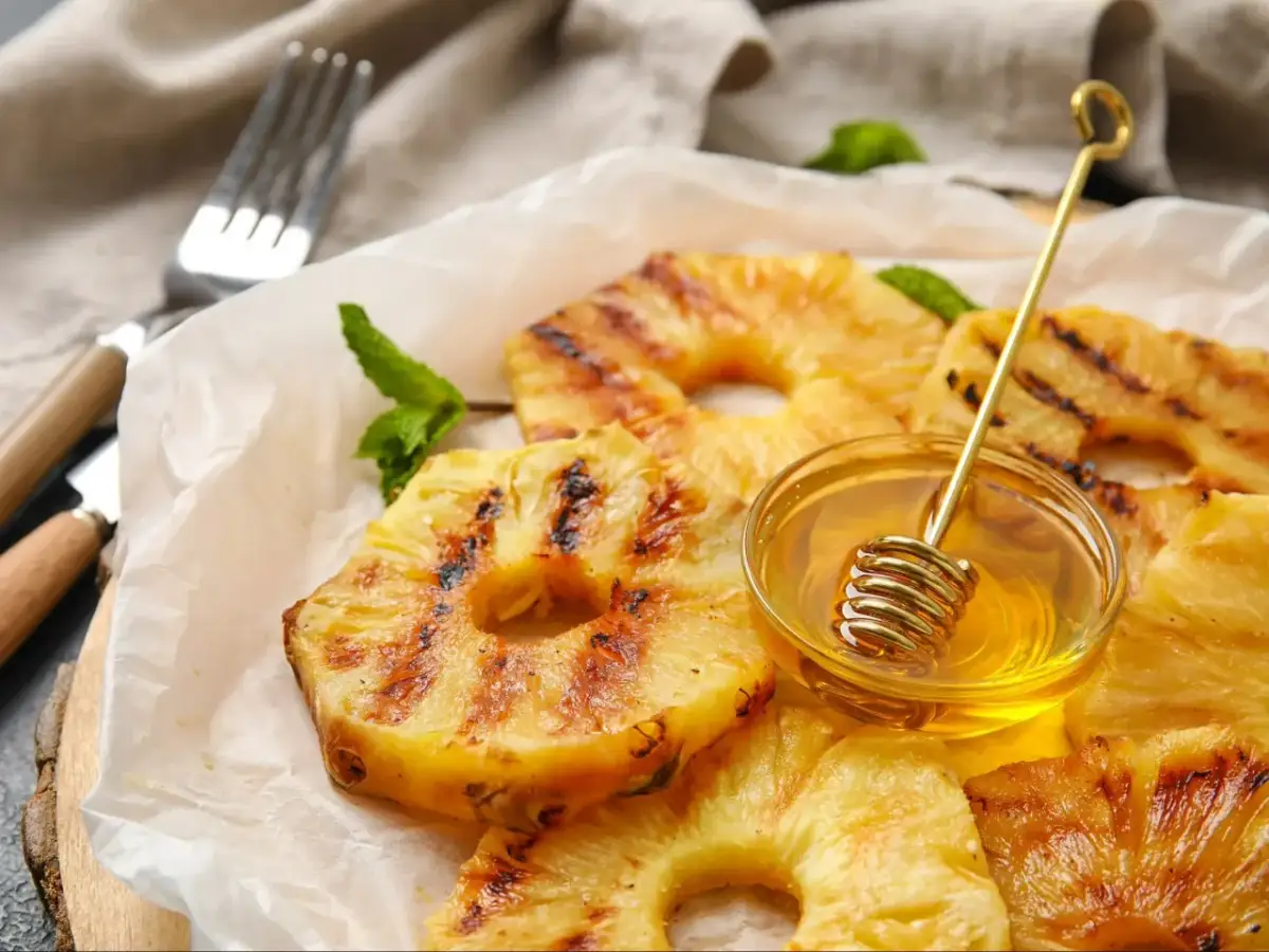 Złocisty, grillowany ananas z miodem i miętą, gotowy do podania.