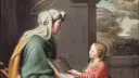 Święta Hanna z córką czytają księgę. Dziecko z zaciekawieniem słucha słów matki, a nad ich głowami unoszą się aureole.