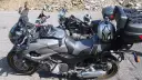 Dwa motocykle Yamaha zaparkowane na drodze szutrowej, jeden z kaskiem na siedzeniu.