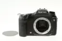 Czarny aparat Pentax K10 z widocznym mocowaniem obiektywu i osłoną. Wewnątrz widoczny jest sensor ccd.