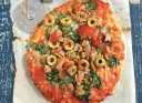 Pyszna pizza z tuńczykiem, szpinakiem i oliwkami, gotowa do pokrojenia.
