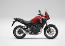 Czerwony motocykl Honda NX 500 z czarnymi elementami, gotowy na przygodę.