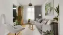 Przytulny salon inspiracje: szara kanapa, fotel, drewniana komoda i mnóstwo zielonych roślin tworzą relaksującą atmosferę.