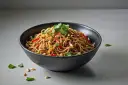 Miseczka makaronu sojowego z chili, orzeszkami ziemnymi i kolendrą.