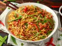 Miseczka makaronu chow mein z warzywami i pałeczkami.