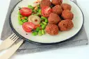 Falafel kontra kotlety sojowe: kulki z ciecierzycy i warzywa na talerzu.