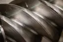 Metalowe śruby kompresora, tworzące przestrzeń do wytworzenia podciśnienia a próżni.