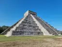 Piramide Kukulkana w Chichen Itza, jeden z Nowych Siedmiu Cudów Świata, majestatycznie wznosi się na tle błękitnego nieba.