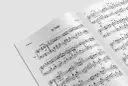 Otwarta księga z nutami "El Coqui" dla pianisty. Widać wszystkie nuty na pięciolinii, oznaczenia dynamiki i tempa.