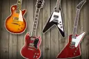 Vier Gibson E-Gitarren: Les Paul, SG, Flying V und Explorer auf Holz Hintergrund.