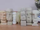 Rząd rzeźbionych w mydle figurek w kształcie głów Moai.