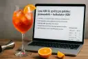 Kieliszek Aperol Spritz obok laptopa z kalkulatorem ABV. Dowiedz się, jak obliczyć ile procent ma drink, korzystając z poradnika.