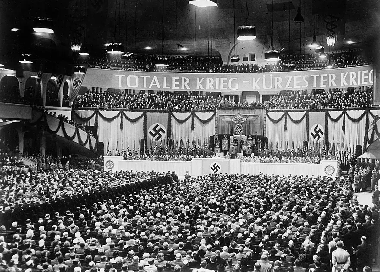 Große Menschenmenge im Sportpalast, die der Sportpalastrede zuhört. Banner verkündet "Totaler Krieg".