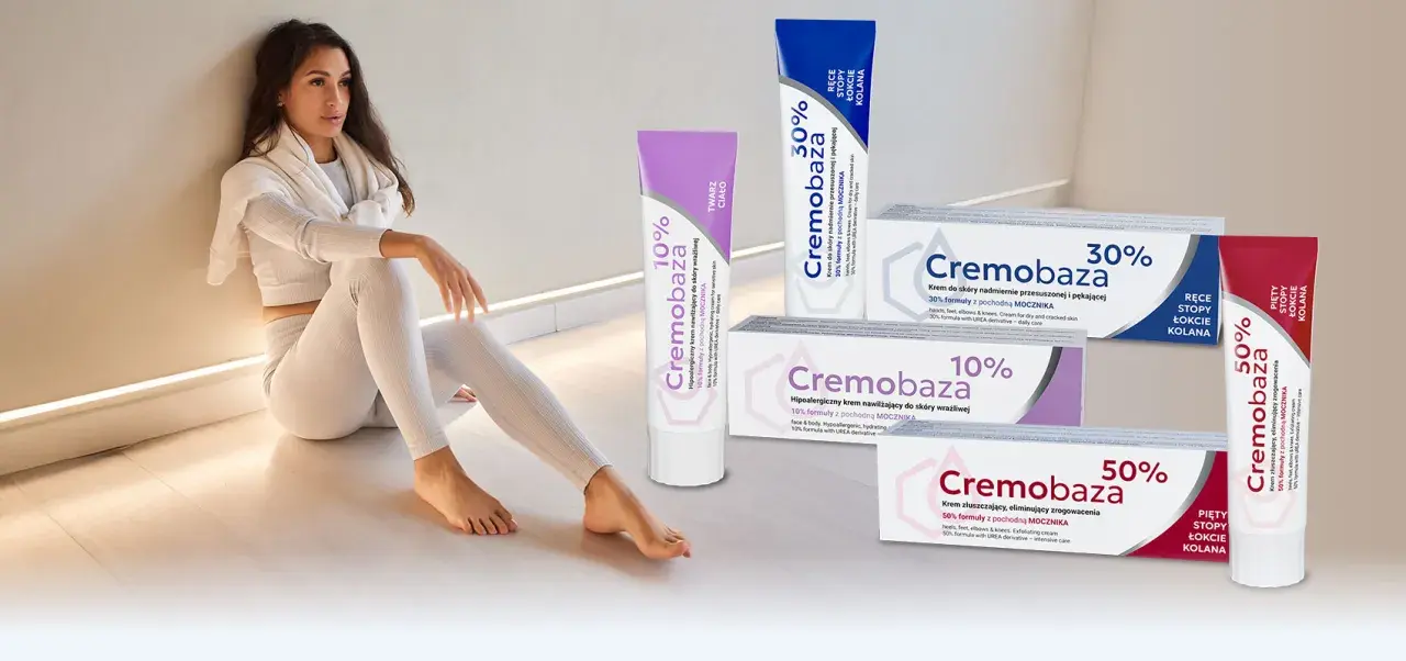 Kobieta w białym stroju siedzi obok tubek z kremami Cremobaza 10%, 30% i 50%.