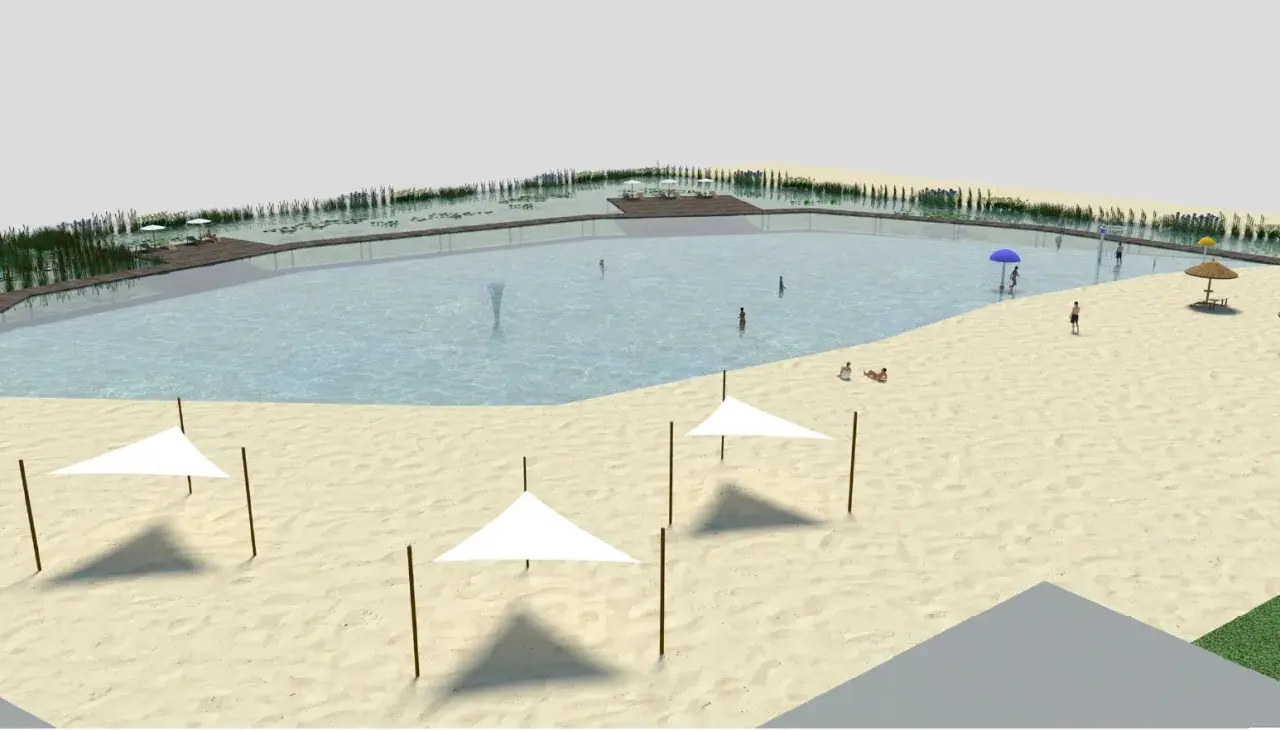 Relaks nad zalewem Cieszanowice: piaszczysta plaża, wodne atrakcje i wypoczynek pod białymi parasolami.