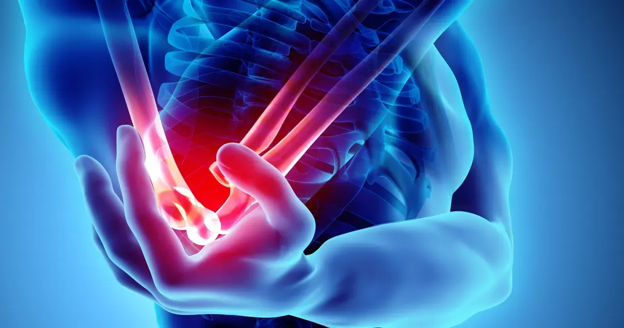 Anatomical rendering of a human arm showing a glowing red area indicating **ból łokcia**.
