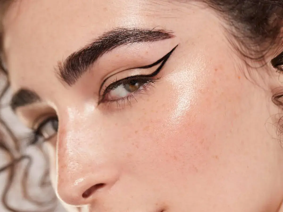 Ojo con delineado cat eye perfecto, cejas definidas y piel luminosa. Un look de maquillaje aesthetic que resalta la belleza natural.
