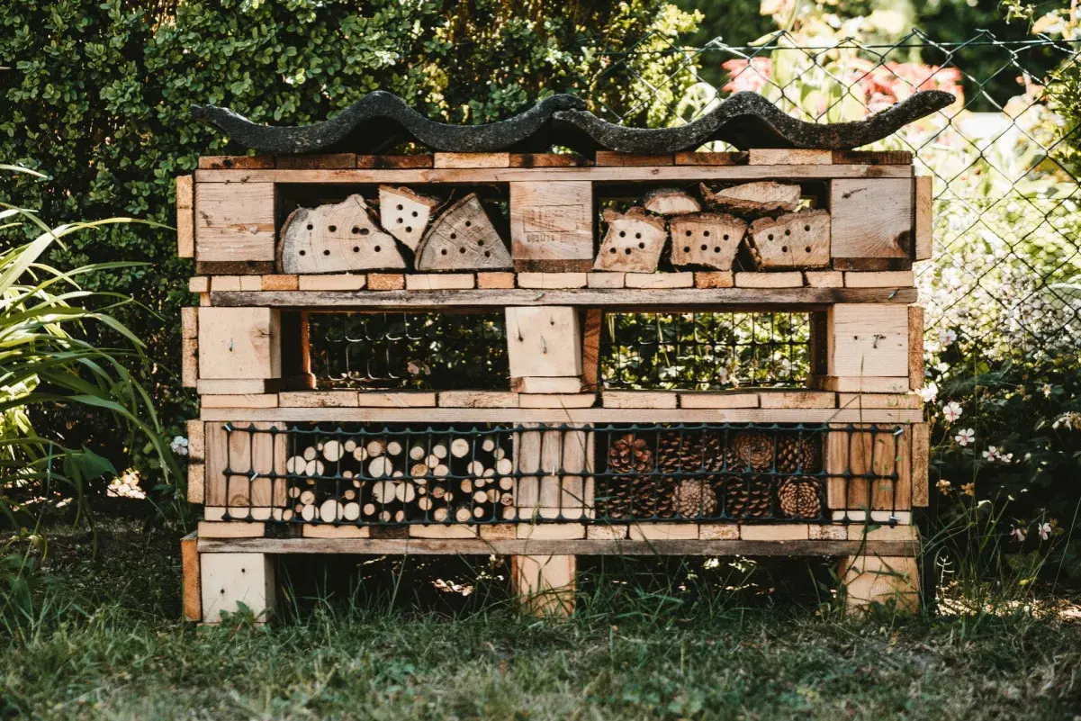 Domek dla owadów z palet, pełen naturalnych materiałów. Świetne upcycling przykłady dla ogrodu.