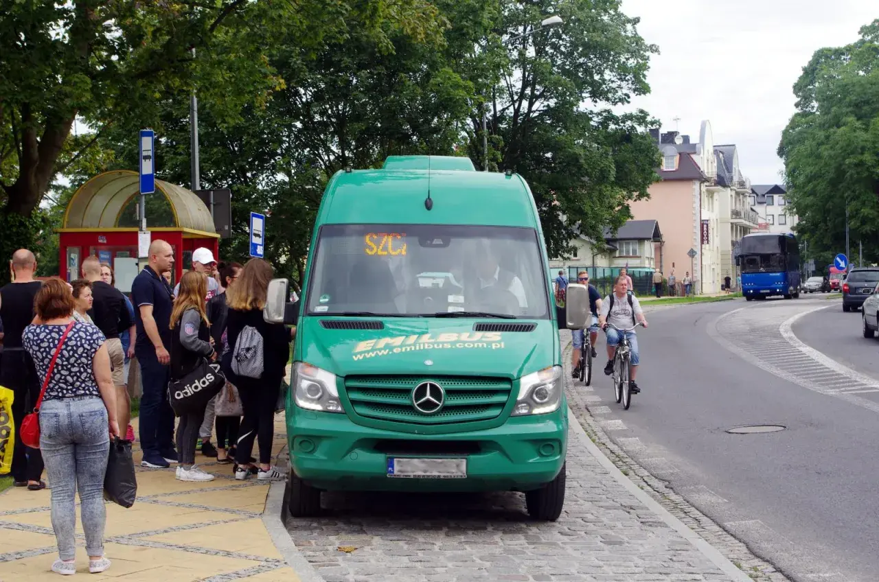 Międzyzdroje busy do Dziwnowa czekają na pasażerów przy przystanku. Zielony bus Emilbus.