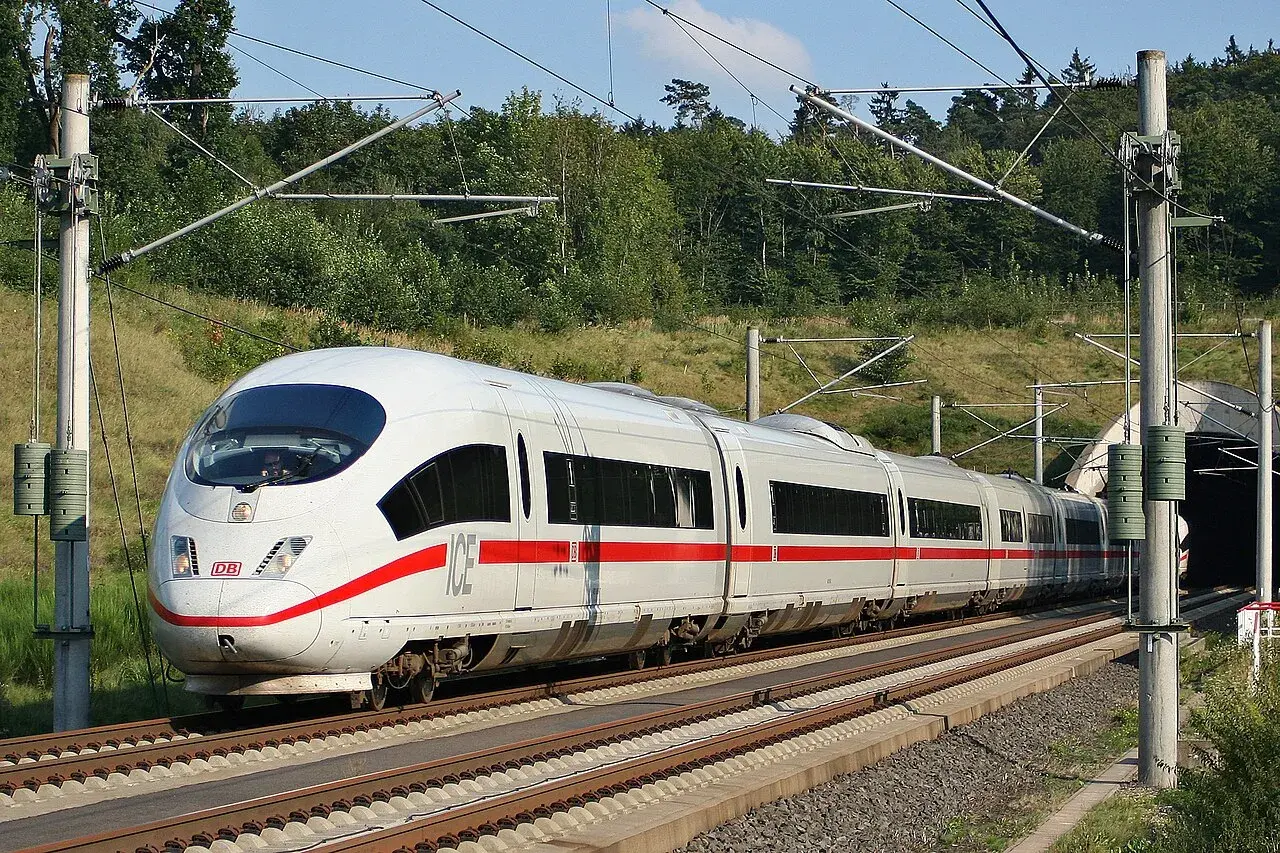Der ICE, der schnellste Zug Deutschlands, fährt auf den Gleisen in Richtung eines Tunnels.