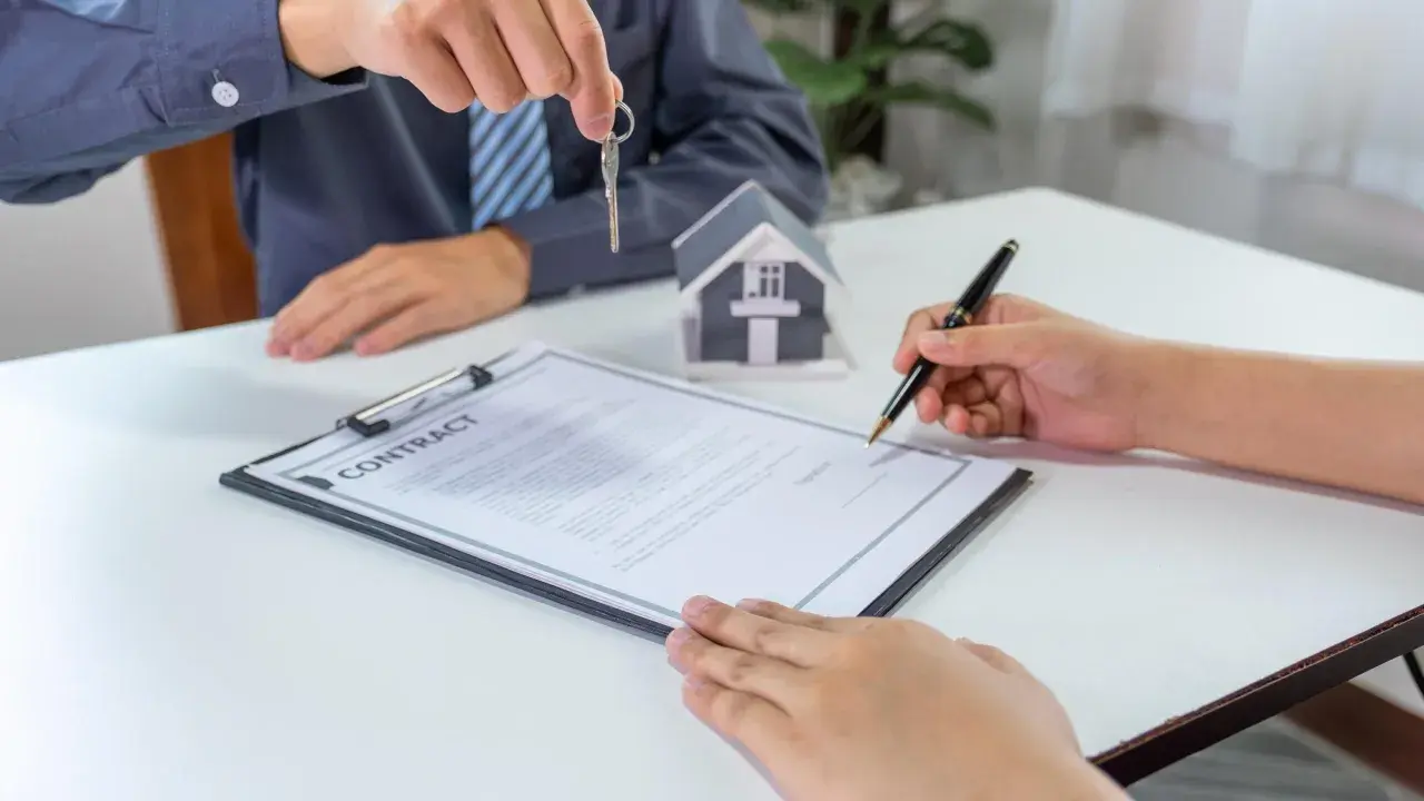 Firma del contratto di compravendita immobiliare con consegna delle chiavi. La procura generale notarile è un atto fondamentale.