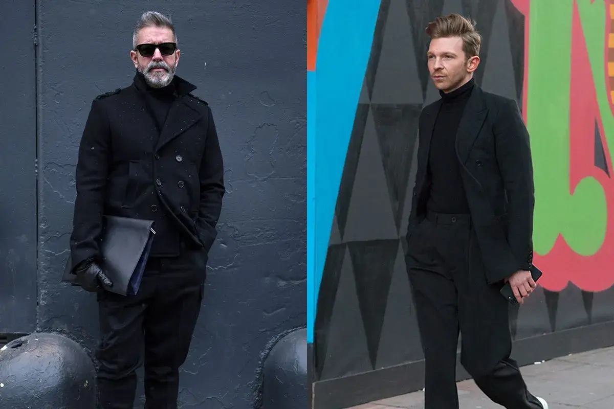 Zwei Männer in elegantem schwarzem Anzug und schwarzem Hemd. Der eine trägt einen Mantel, der andere einen Blazer.