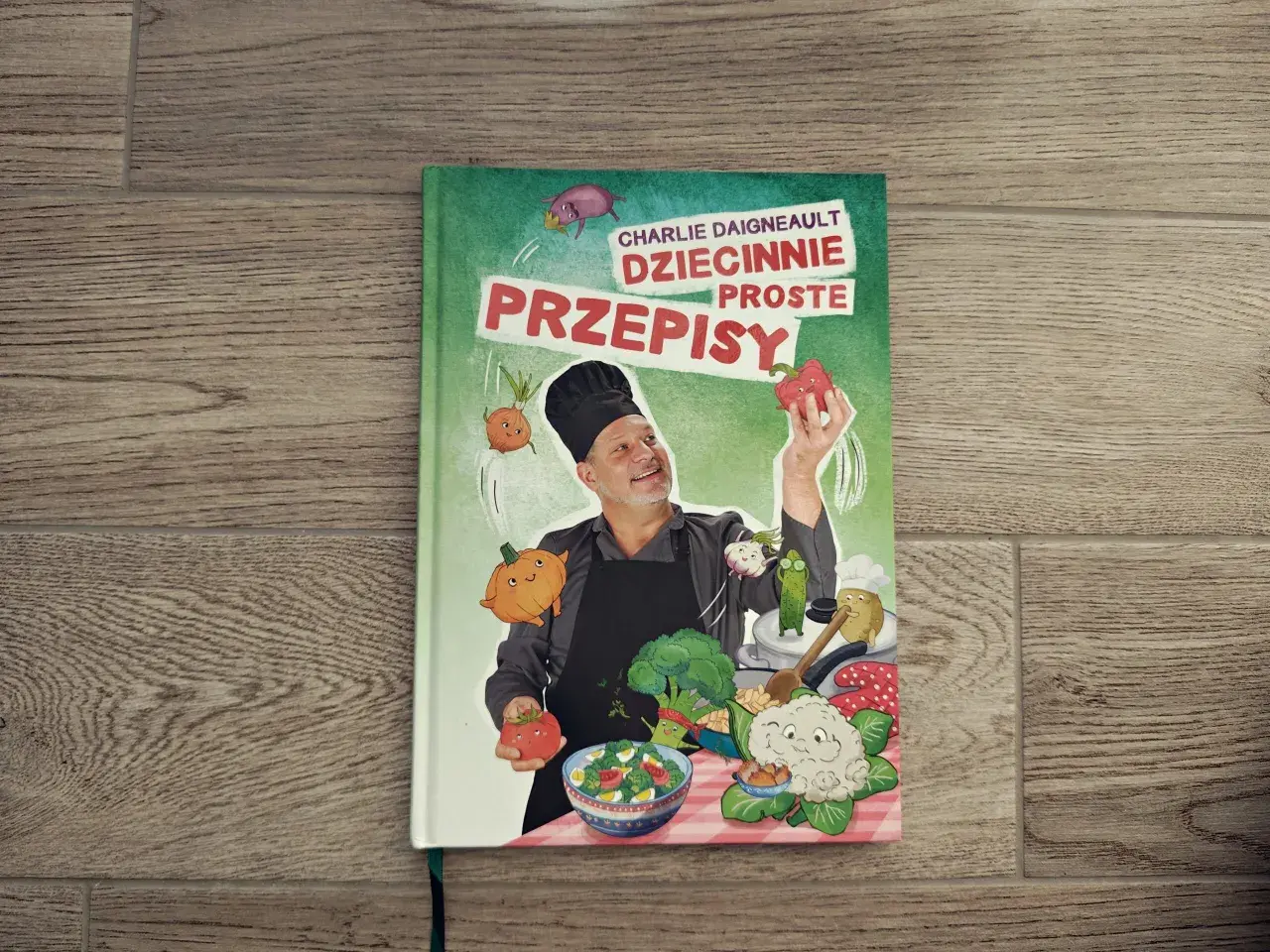Książka "Dziecinnie proste przepisy" Charlie'ego Daigneaulta. Pokazuje, co może ugotować 10 latka, z zabawnymi warzywami i szefem kuchni.