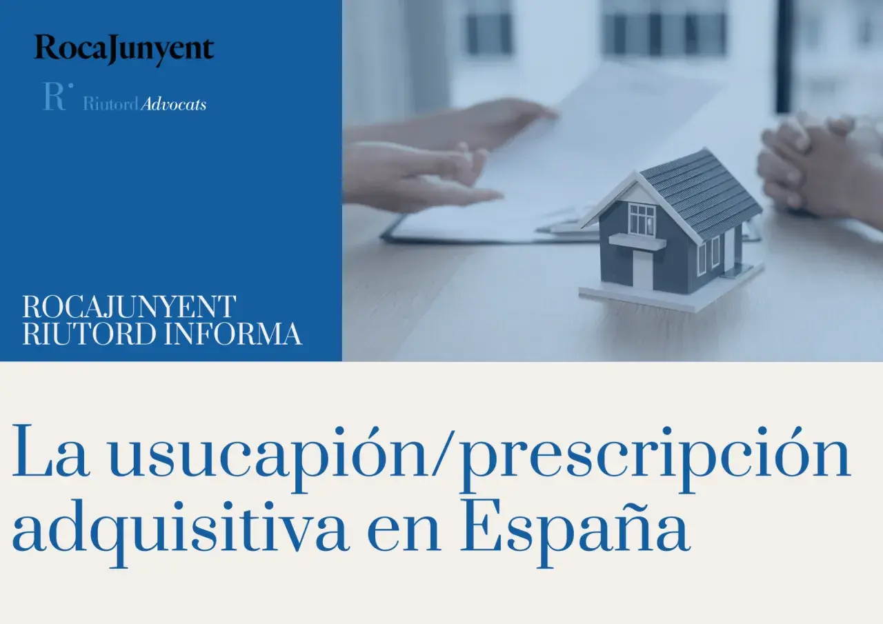 Manos revisando documentos junto a una maqueta de casa, explicando qué es usucapión en España.