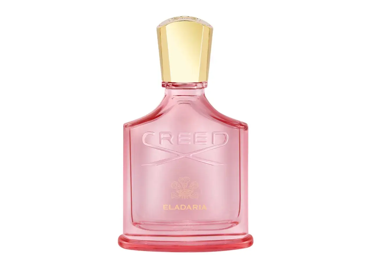 Różowa butelka perfum Creed Eladaria ze złotą nakrętką.