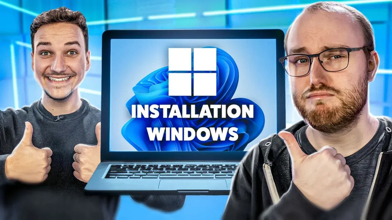 Deux hommes font un pouce levé devant un écran d'ordinateur affichant "INSTALLATION WINDOWS" et le logo Windows 11.