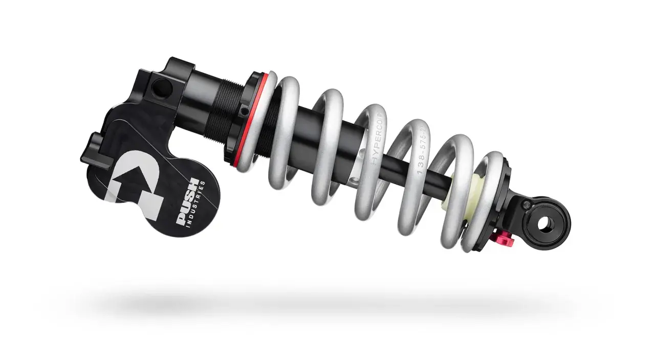 A PUSH Industries 11-6 rear shock absorber with a silver coil spring and black body, ready to tackle any trail.