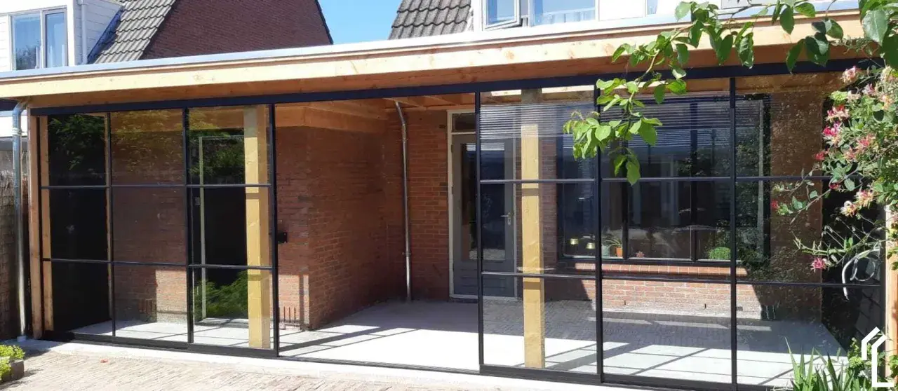 Neues Flachdach-Anbaudach mit Stahlrahmenfenstern. Ein schönes Projekt, um das eigene Dach selber bauen zu können.