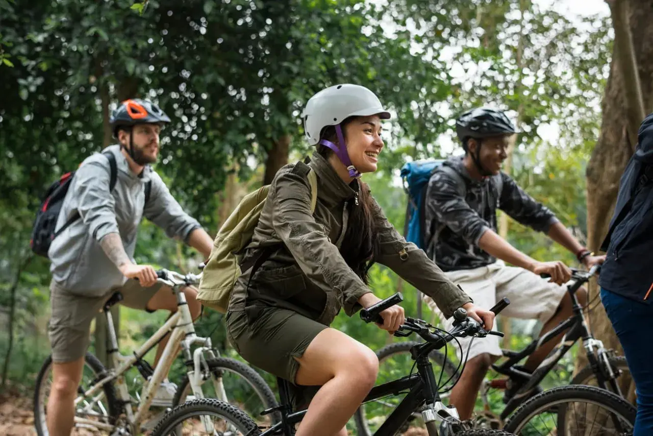 Friends enjoying a scenic ride through the woods, a perfect scene for France bicycle tours.