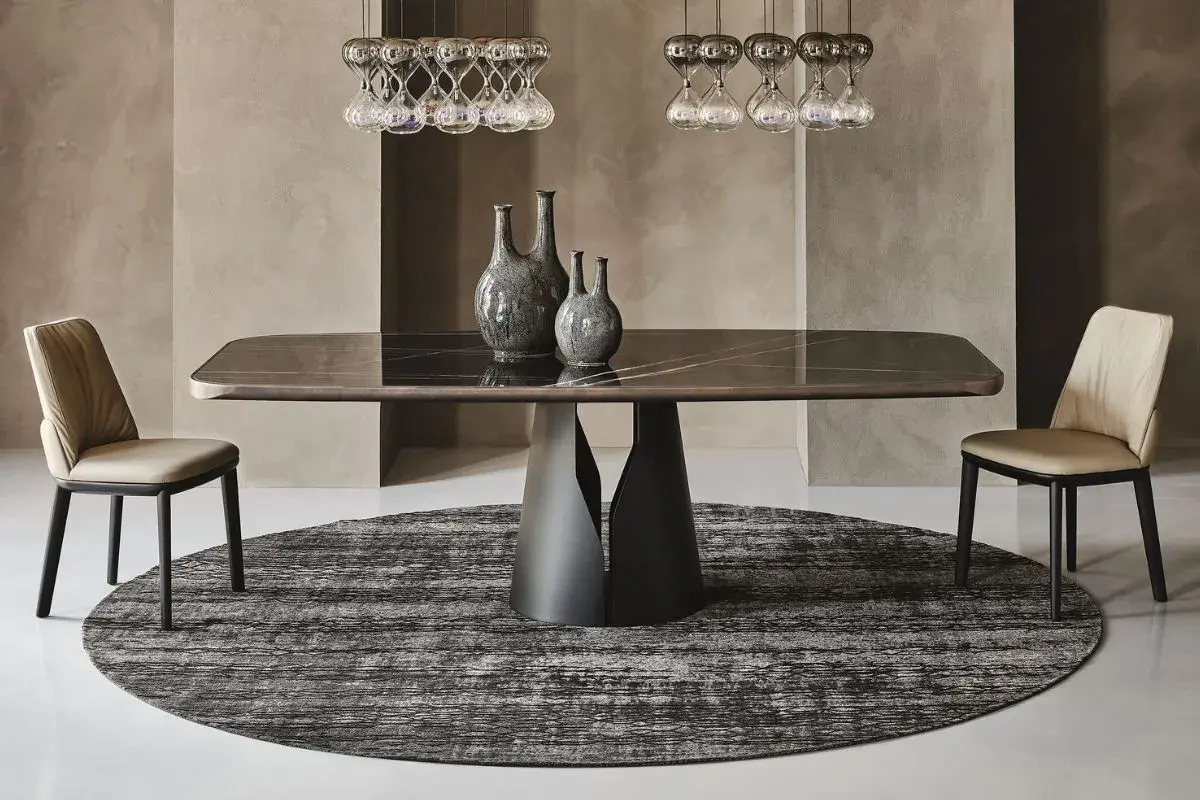 Tavolo rettangolare con base scultorea, due vasi decorativi e sedie eleganti. Ideale per chi cerca cosa mettere su un tavolo rettangolare.
