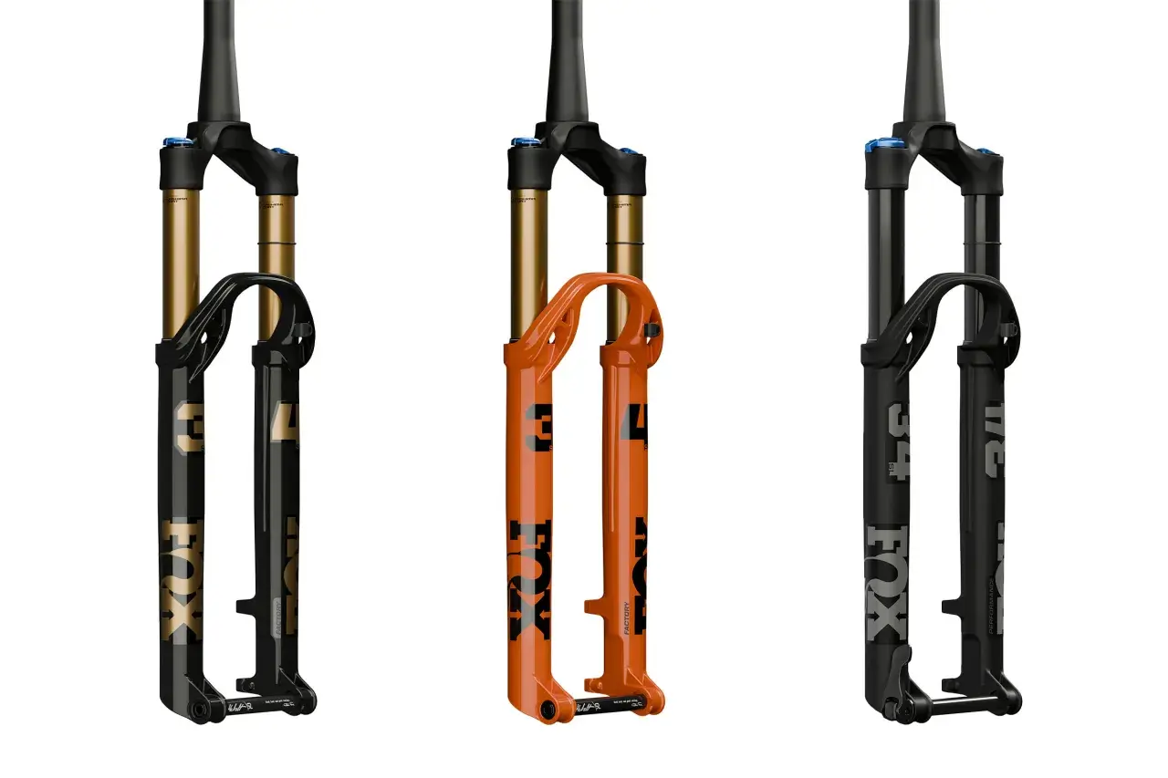 Three Fox Float SL suspension forks: one black with gold accents, one bright orange, and one matte black. Ready to float over any terrain.