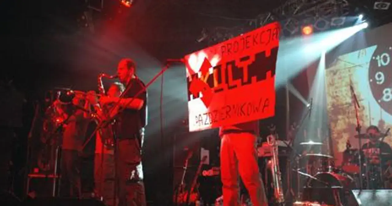 Koncert z instrumentami dętymi i banerem "PROJEKCJA KULTU PAZERMIKOWA". Koniec tekst.